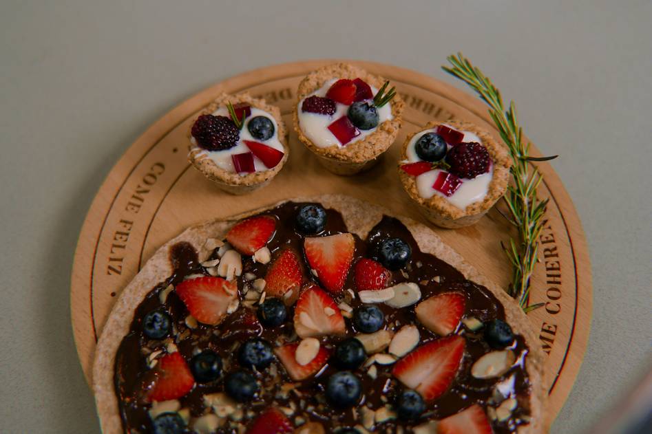 Blogger preparing organic chocolate avocado mousse with fresh herbs